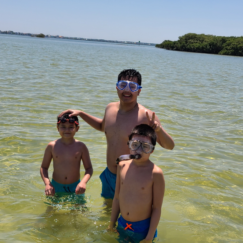 three boys in the shallow water at the Flats